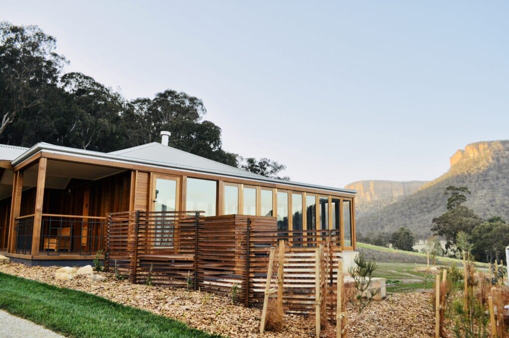 Energy-efficient eco lodge building in a natural landscape demonstrating carbon footprint reduction